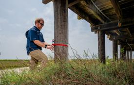 In addition to relying on data from more expensive 哨兵, engineering professor Dr. Bret Webb will deploy smaller storm surge and wave gauges in advance of a hurricane. They can be affixed to structures such as this pier on Dauphin Island.